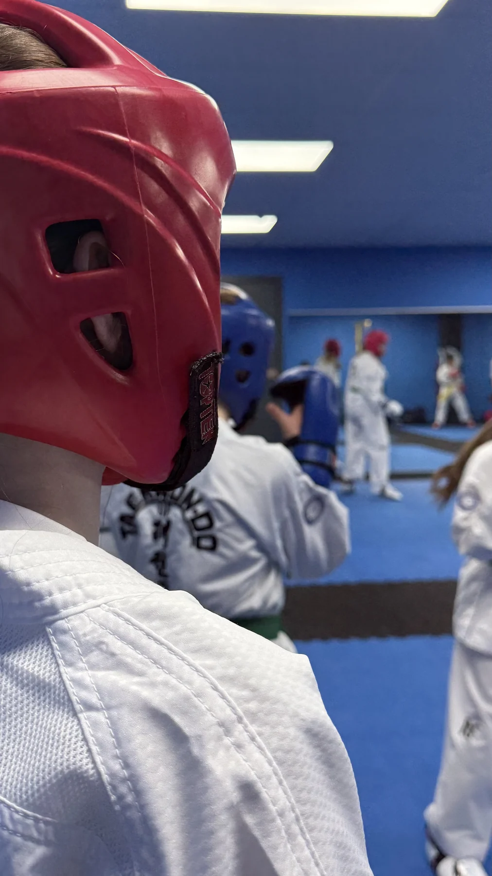 Taekwon-Do students wearing headguards and white ITF uniforms during a Braveheart class
